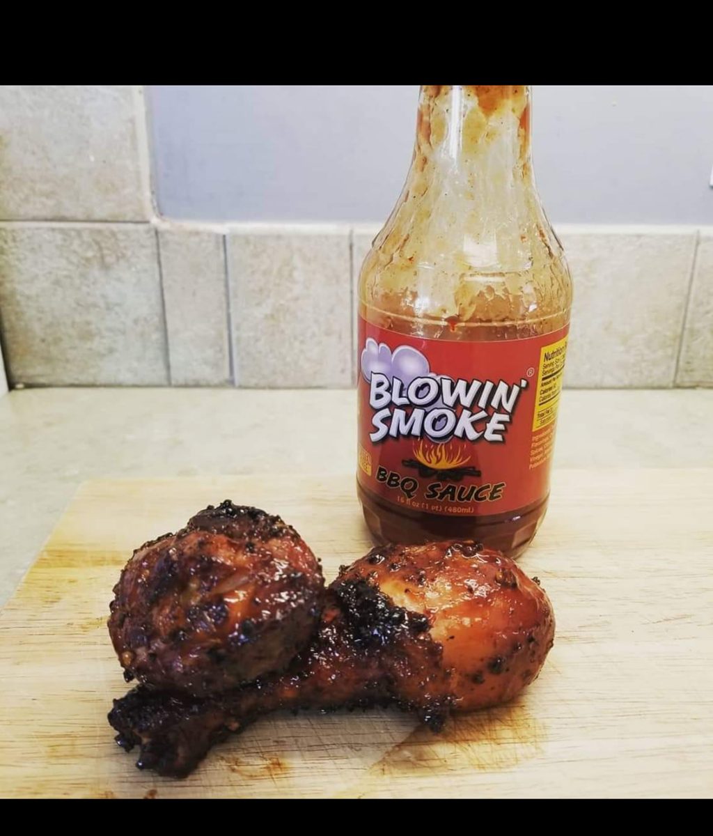chicken legs covered in Blowin smoke bbq sauce